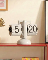 Side view of white gear-operated flip clock showing the internal mechanism and sleek industrial design.