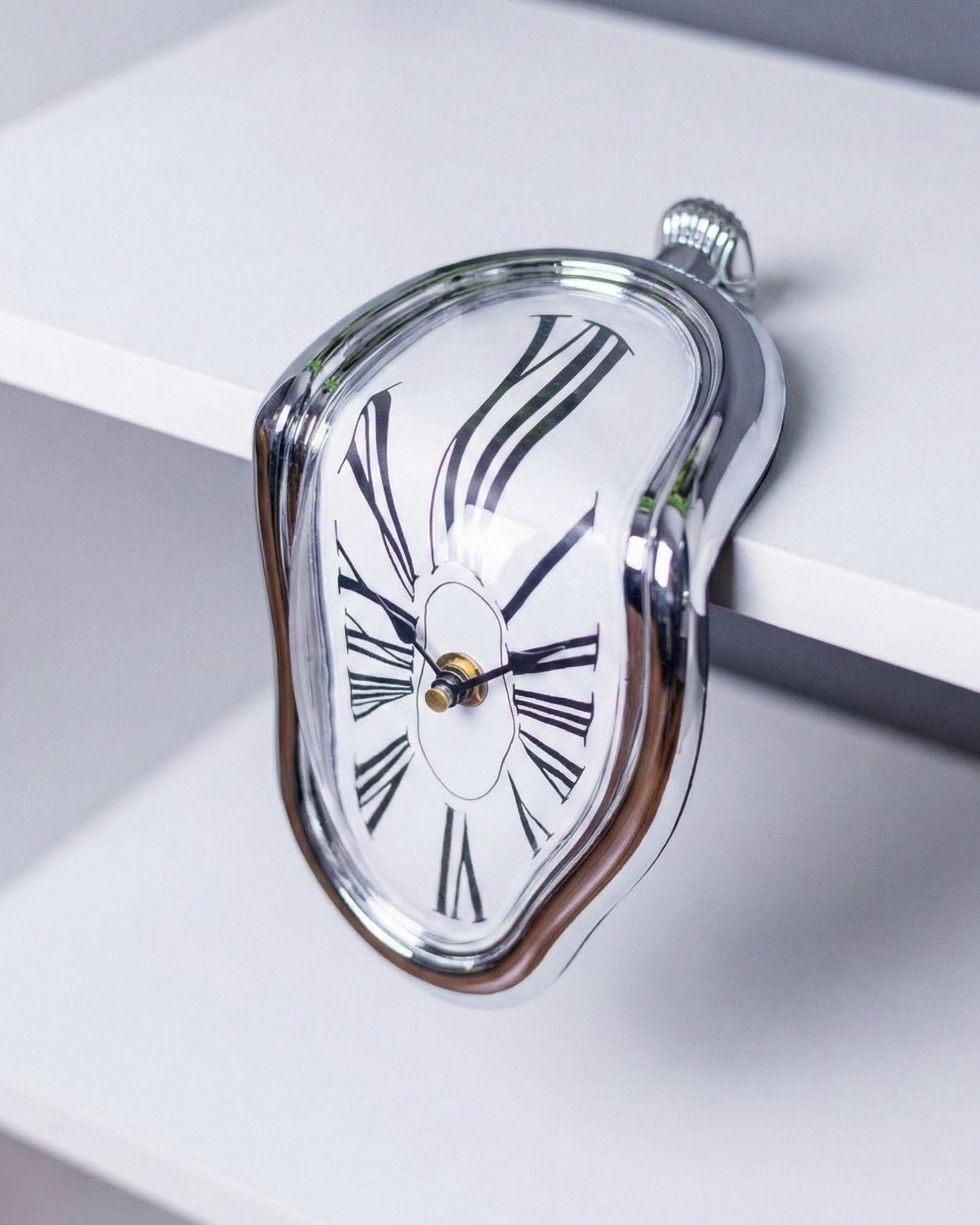 Side profile of Silver Chrome Melting Clock draped over 90 degree shelf edge