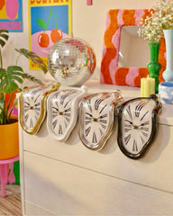 RabbitHole Melting Clock Collection showing Gold Silver Black and White color options Decor