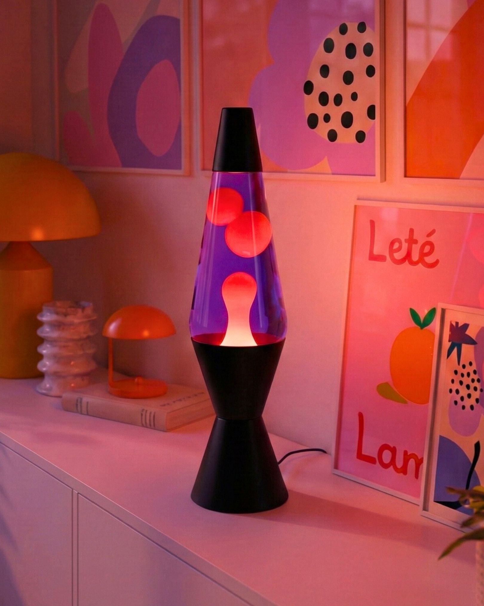 Close-up of the black metal base and power cord of the plug-in electric lava lamp.