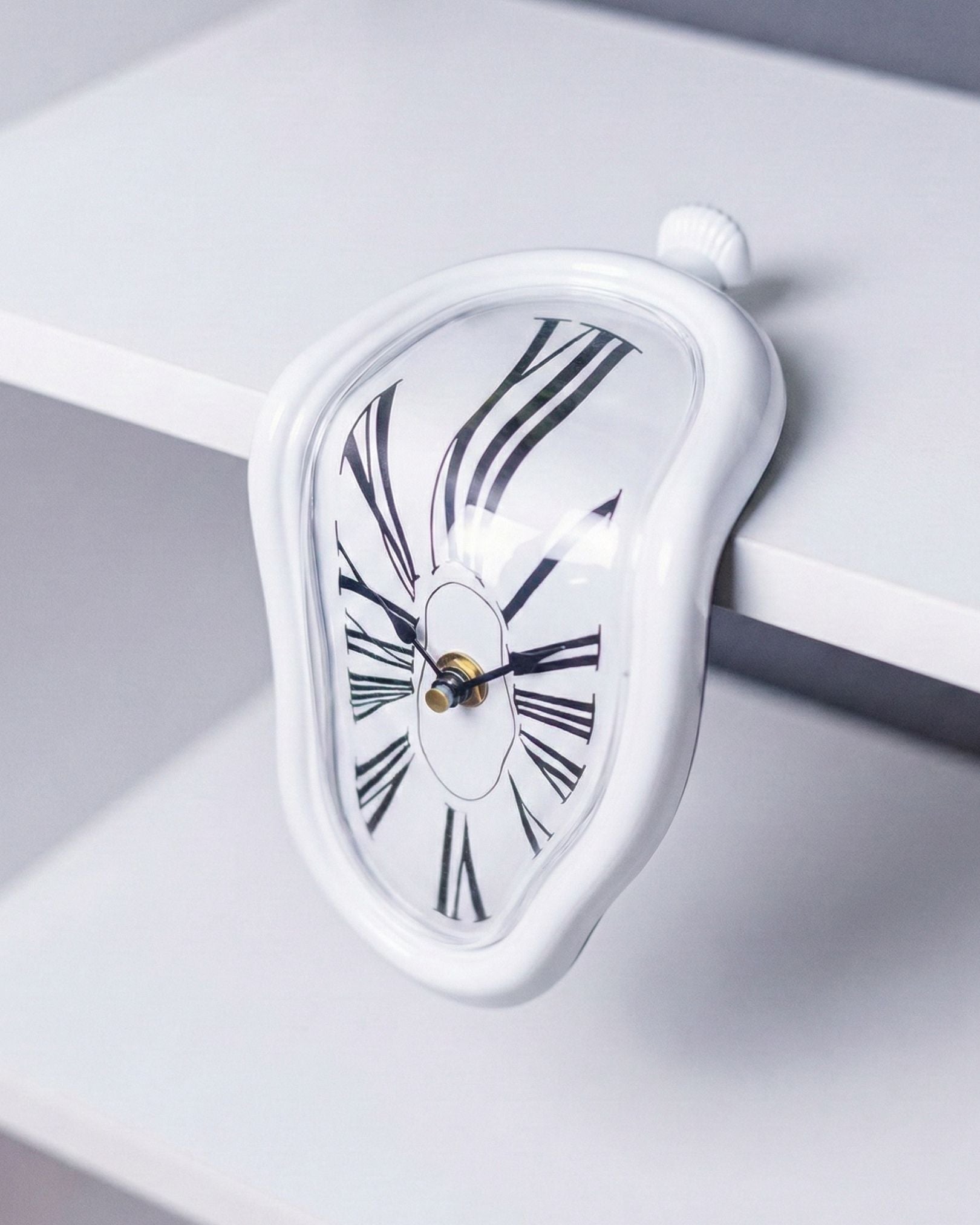 Side angle of White Melting Clock resting on bookshelf edge