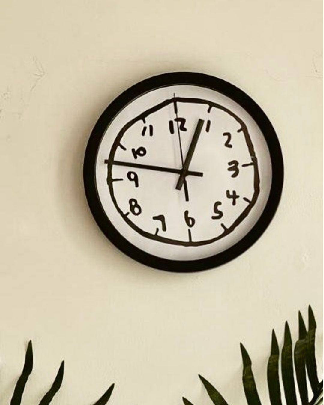 Silent wall clock featuring a modern black and white abstract doodle art design, 30cm diameter.